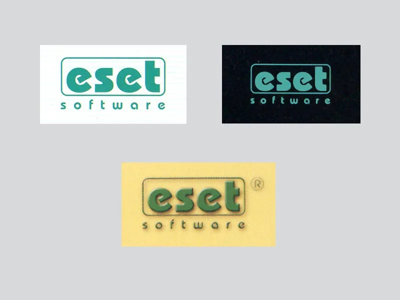 Tres variantes del primer logotipo «eset software», en verde, sobre fondo blanco, negro y amarillo.